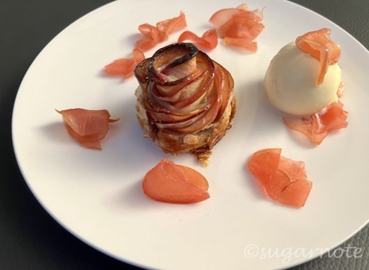 Rose shaped apple pastry with ice cream and sliced apples